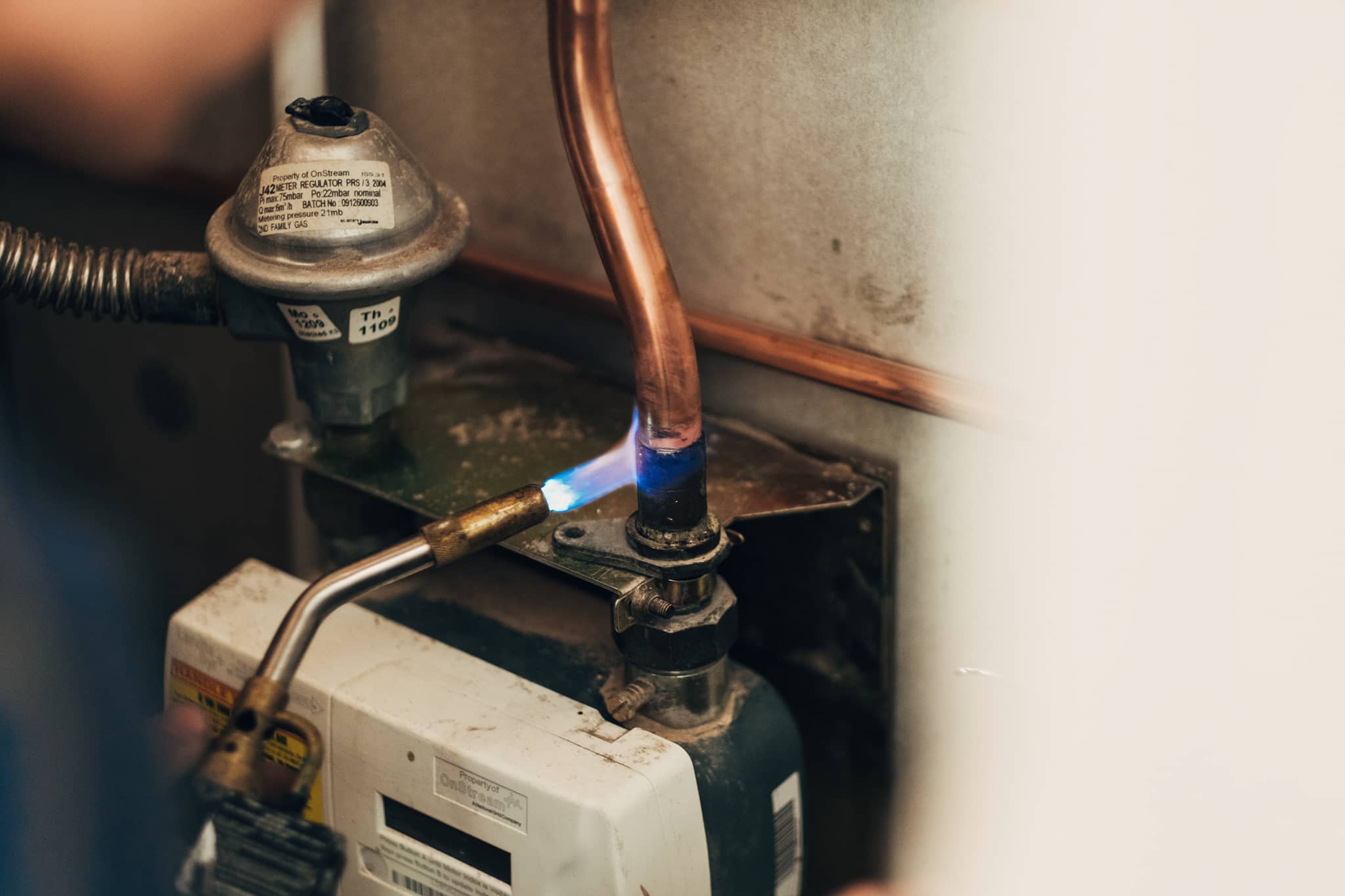 A man is servicing a water heater.
